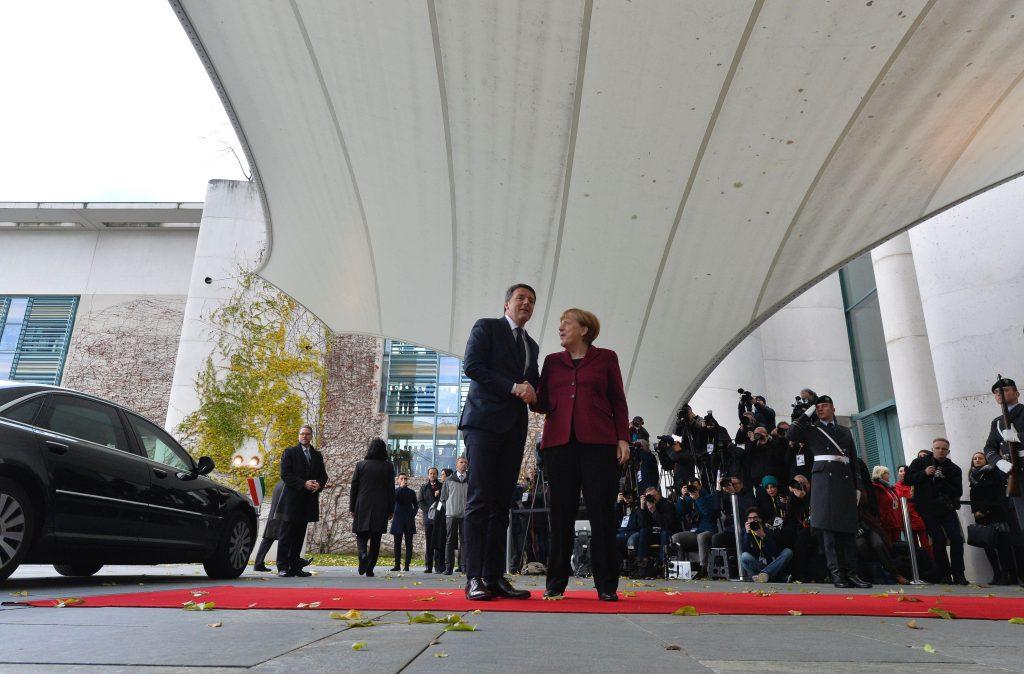 German Chancellor Angela Merkel, right, welcomes Italian Prime Minister Matteo Renzi as he arrives for a meeting of the U.S. president with European leaders on Nov.