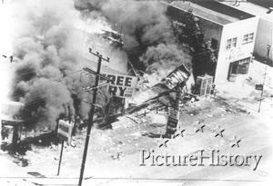 Three stores burn to the ground on Avalon Boulevard in the Watts section of Los Angeles during