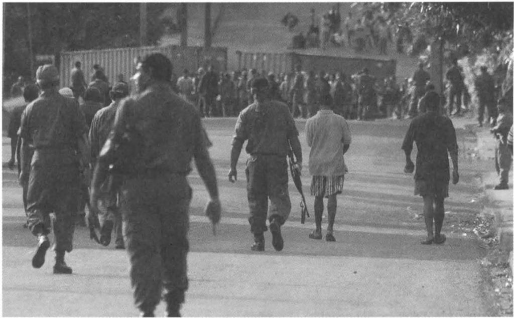 ANOTHER MILITARY COUP 141 Soldiers walk toward Speight's machete-wielding rebels near Pa rliament.