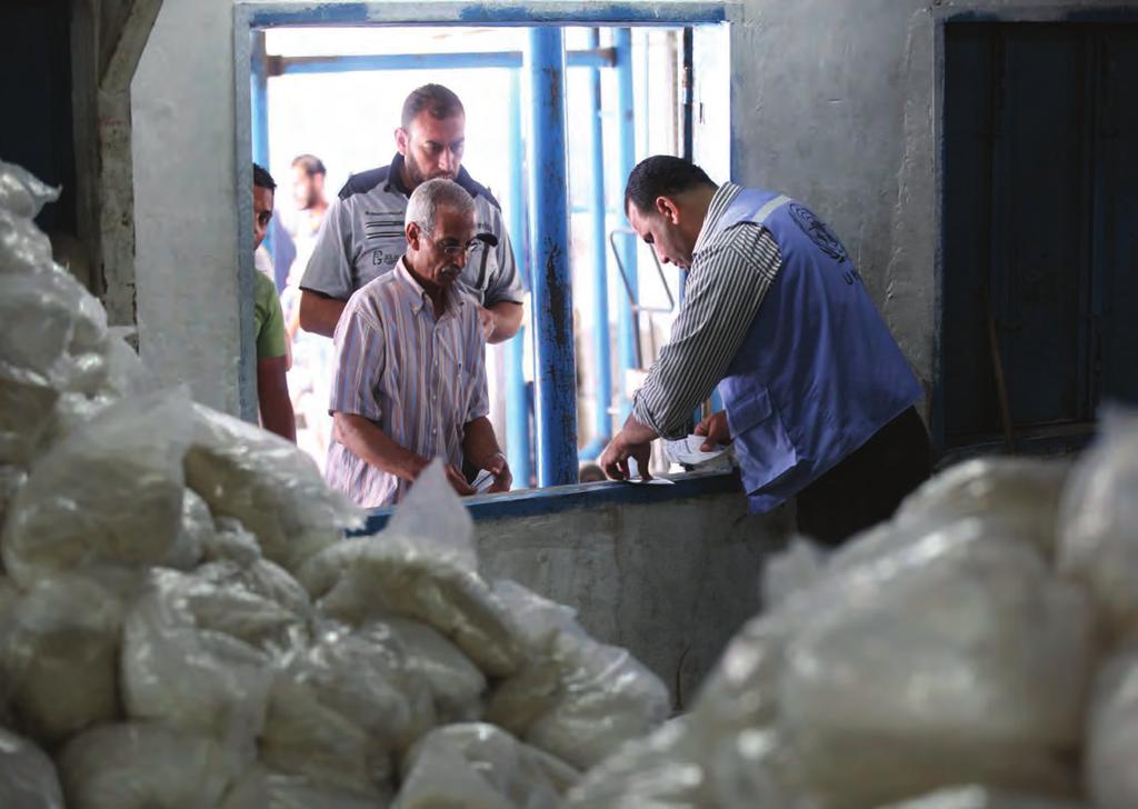 17 2016 opt emergency appeal gaza: sector-specific interventions Refugees collect emergency food parcels at the UNRWA Distribution Centre in Beach refugee camp, August 2015.