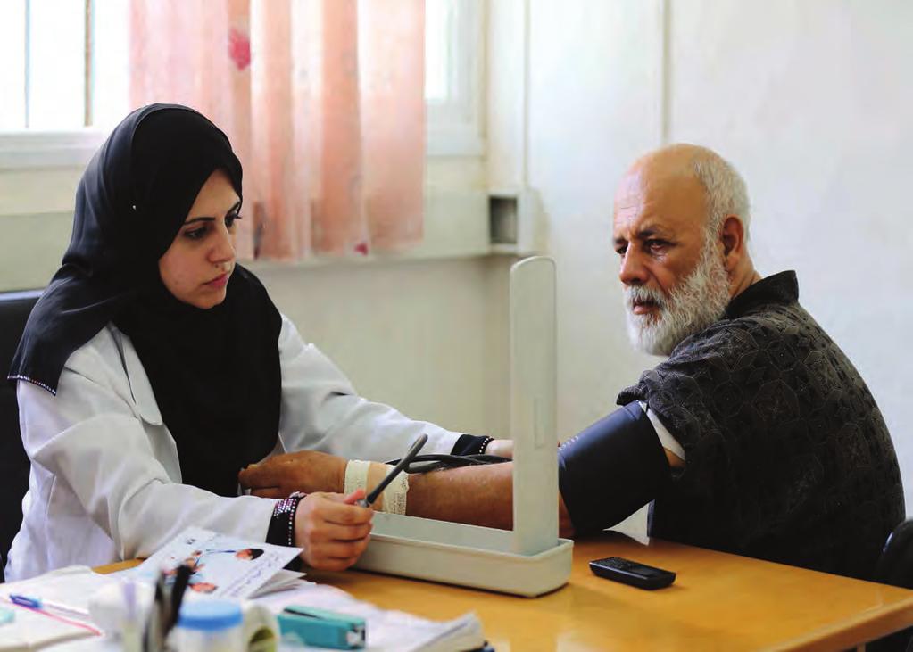 21 2016 opt emergency appeal UNRWA nurse Elham Abu Hassan with a patient at the UNRWA Rimal Health Centre, August 2015.