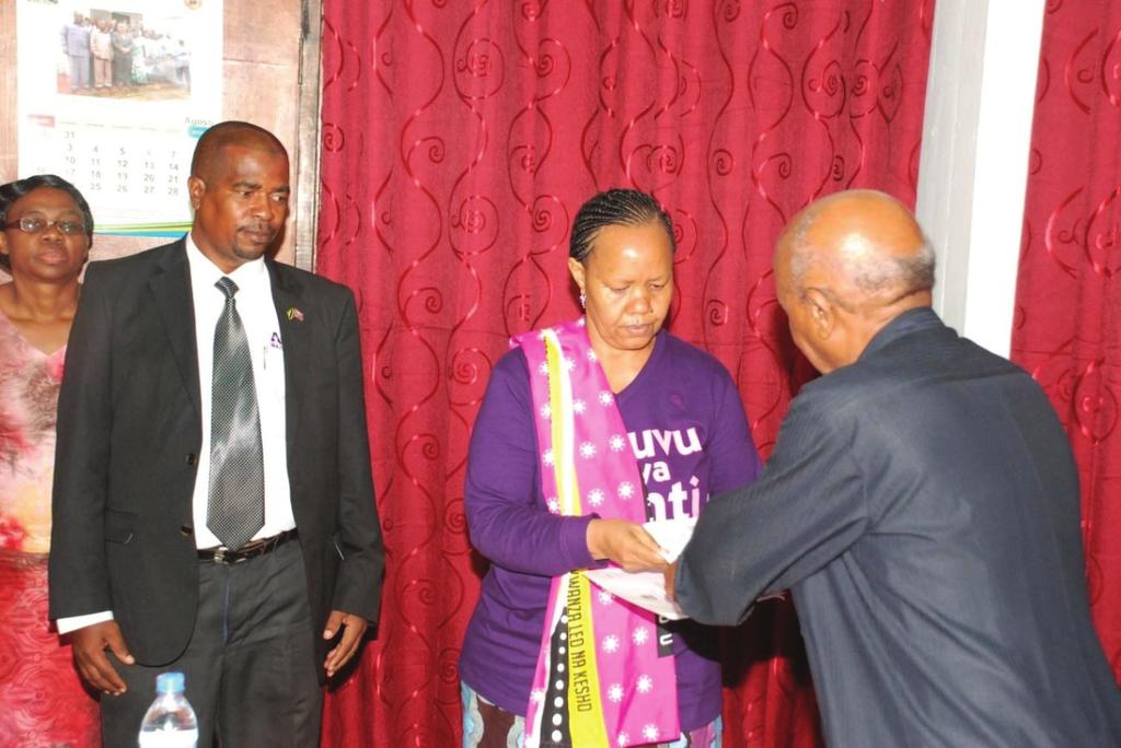 Justice (Rtd) Damian Z. Lubuva (Right), receiving nomination forms from ACT- Wazalendo Presidential Candidate Ms.