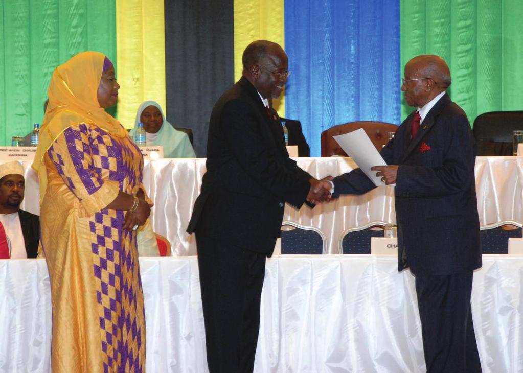 The Chairman of the National Electoral Commission, Hon. Justice (Rtd) Damian Z. Lubuva (right) handing over the Election Certificate to the President-elect of the United Republic of Tanzania Hon. Dr.