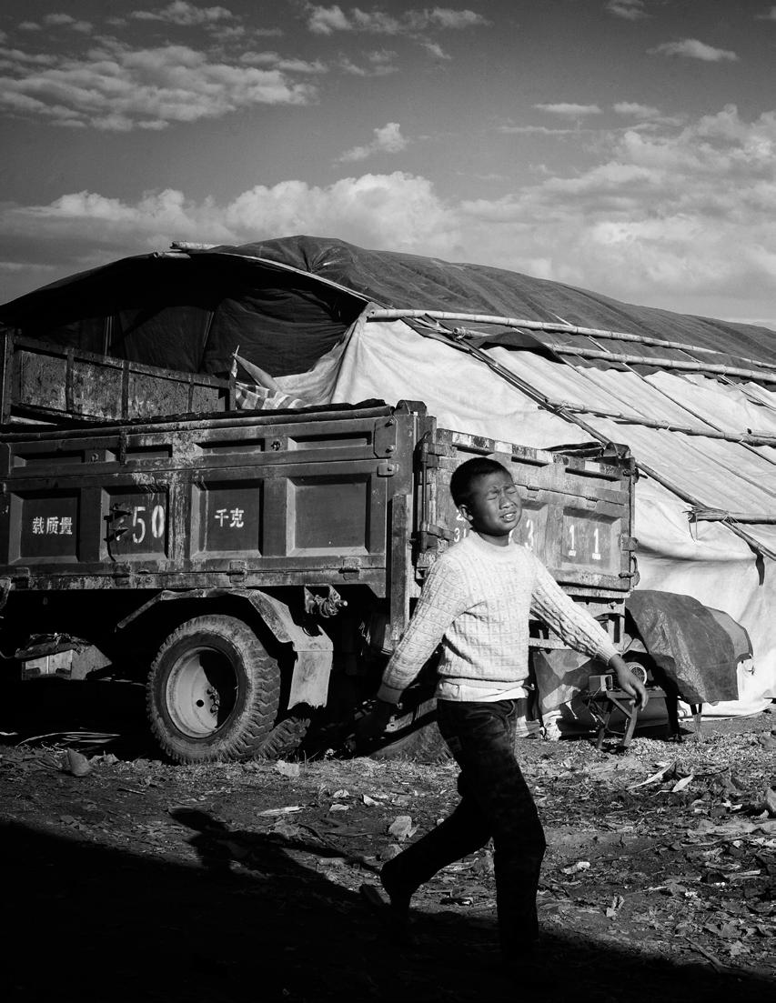 A Kachin boy outside an unrecognized refugee camp