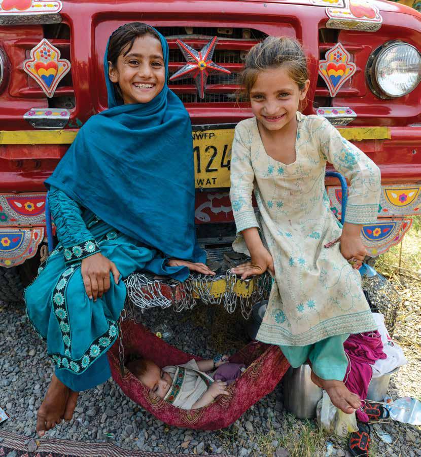 UNHCR / I. Szabó Sisters Salma, 10 and Saima 7, look after baby Moustafa while their parents arrange their long-awaited return home to Afghanistan.