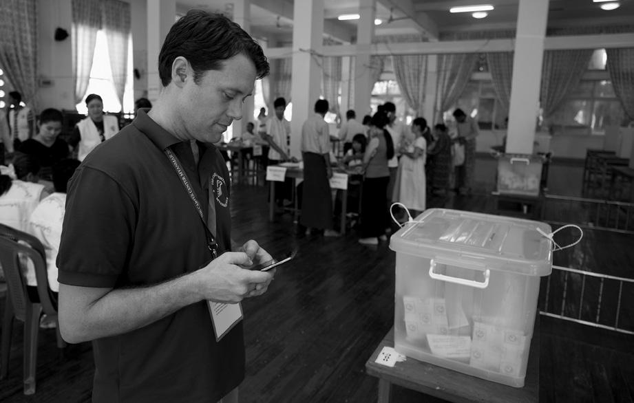 Ron Borden Carter Center observer Jason Carter fills out an ELMO checklist on a tablet at a polling station in Yangon.