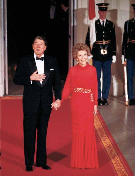RONALD AND NANCY REAGAN The president and the first lady greet guests at a White House social event.