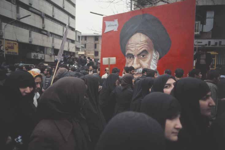 FROM THE AGE OF LIMITS TO THE AGE OF REAGAN 69 WAITING FOR KHOMEINI Iranian women, dressed in traditional Islamic garb, stand in a crowd in Teheran waiting for a glimpse of the Ayatollah Khomeini,