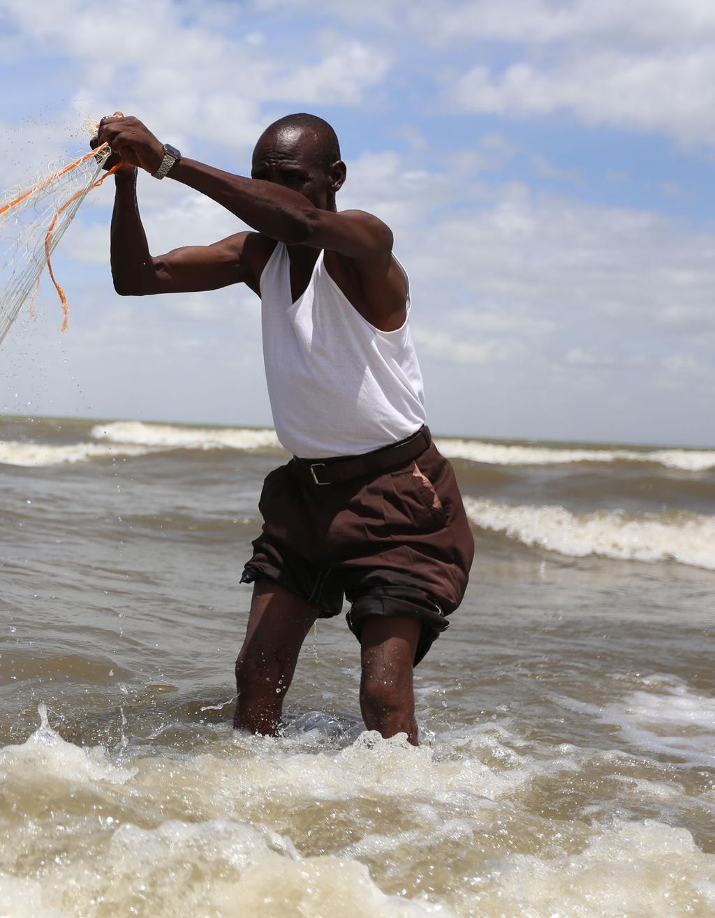 Peter a fisherman and trader, fishing in Lake Turkana Photo: Brian Inganga/Oxfam Front cover photo: The women