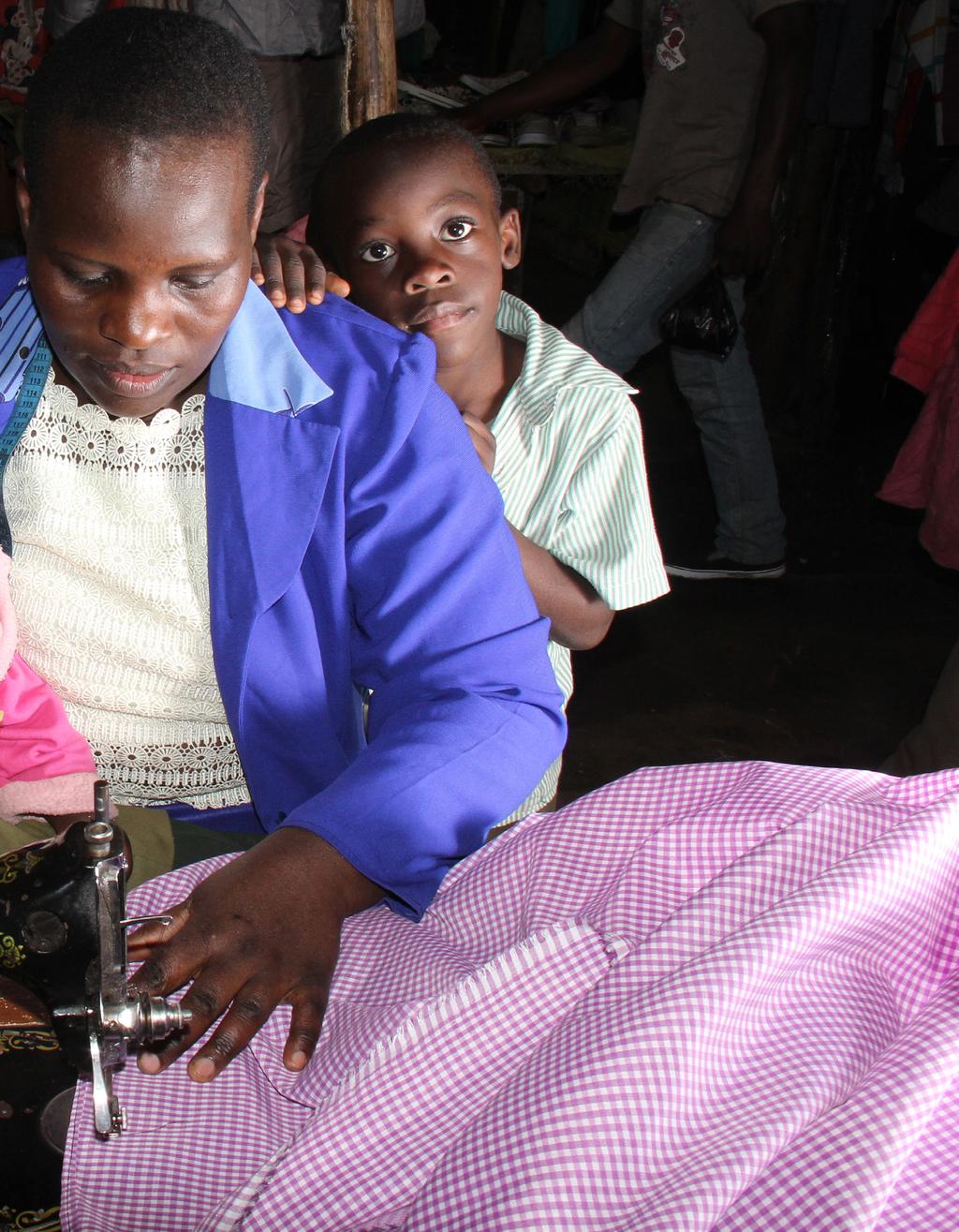 Teresia, a small scale trader at her tailoring kiosk in Kibera informal settlement with her two children.