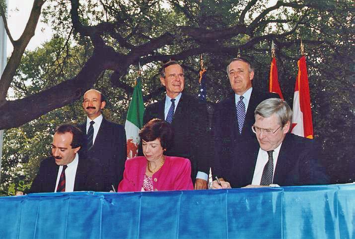Neoliberalism Signing of NAFTA in 1994: Right: (standing)prime Minister Brian Mulroney (Canada) Middle: