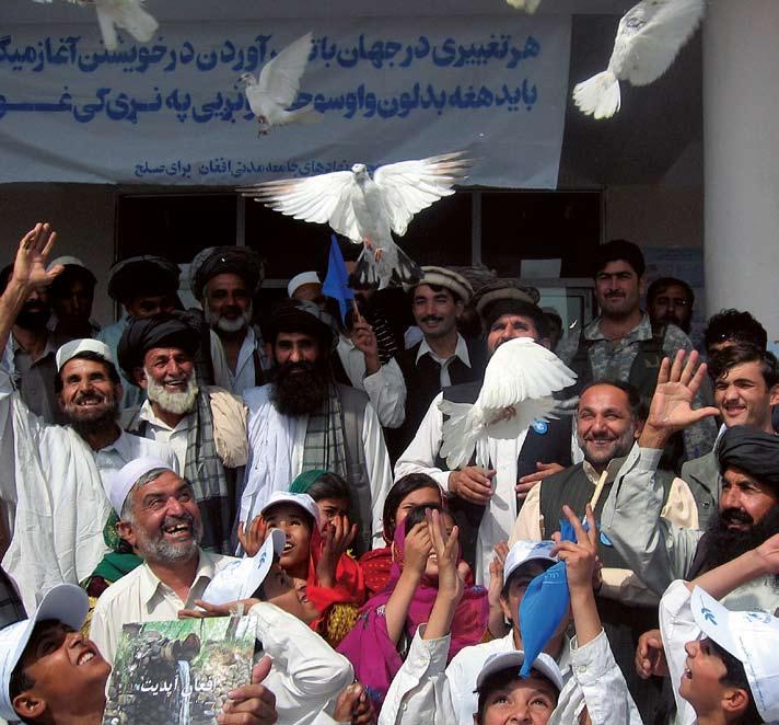 FN A group of people celebrate International Peace Day by releasing white doves as a symbol of peace.