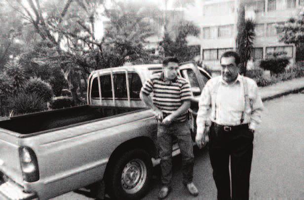 Dr. Ceballos walks towards his house in a residential neighborhood of Medellín, with one of his bodyguards.
