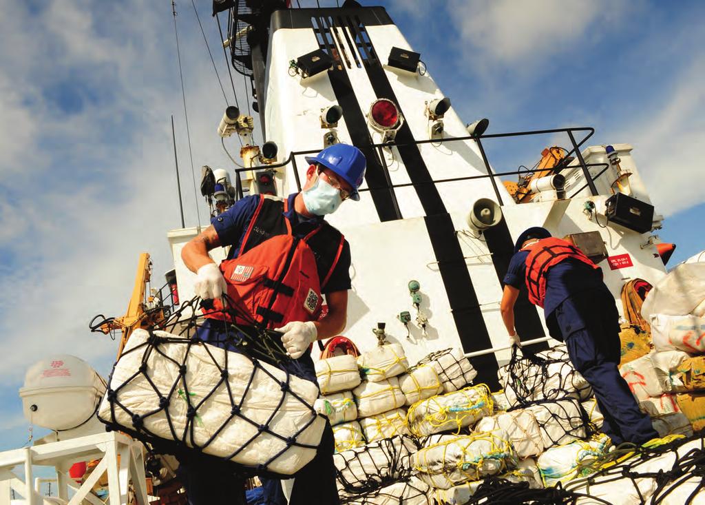 U.S. Coast Guardsmen unload $36 million worth of confiscated cocaine and marijuana, St.