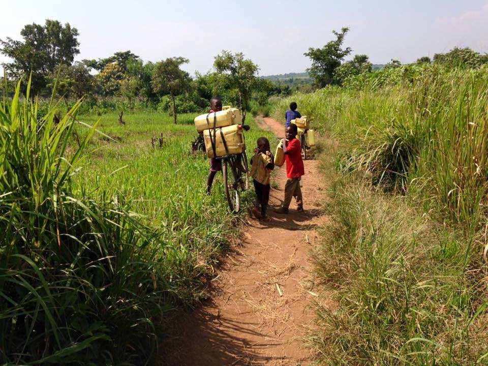 b)the people including children of the families which remained in Kabaale Village going to fetch water in a dirty pond