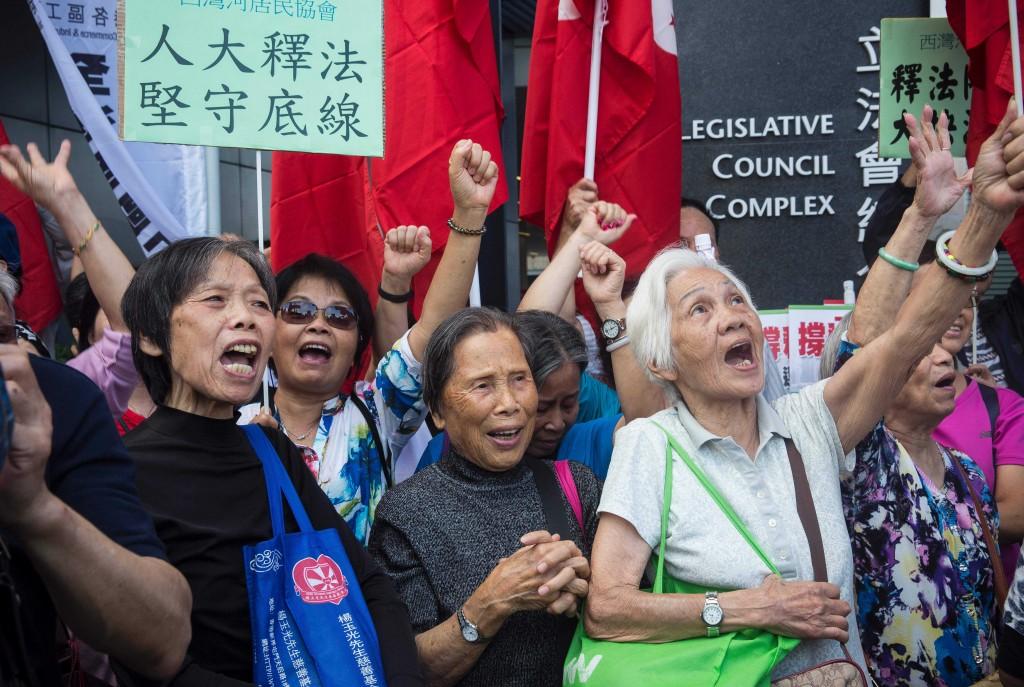 Pro-Beijing demonstrators shout slogans outside Hong Kong s Legislative Council on Nov. 13, 2016.