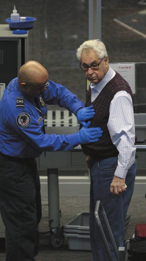 A Transportation Safety Administration (TSA) worker screens an airline traveler. The TSA is a division of the Department of Homeland Security.
