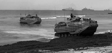 HUMANITARIAN INTERVENTION U.S. Marine armored amphibious vehicles emerge from the surf onto the beach at the airport at Mogadishu, Somalia, 5 January 1992. The Marines were the vanguard of an armed U.