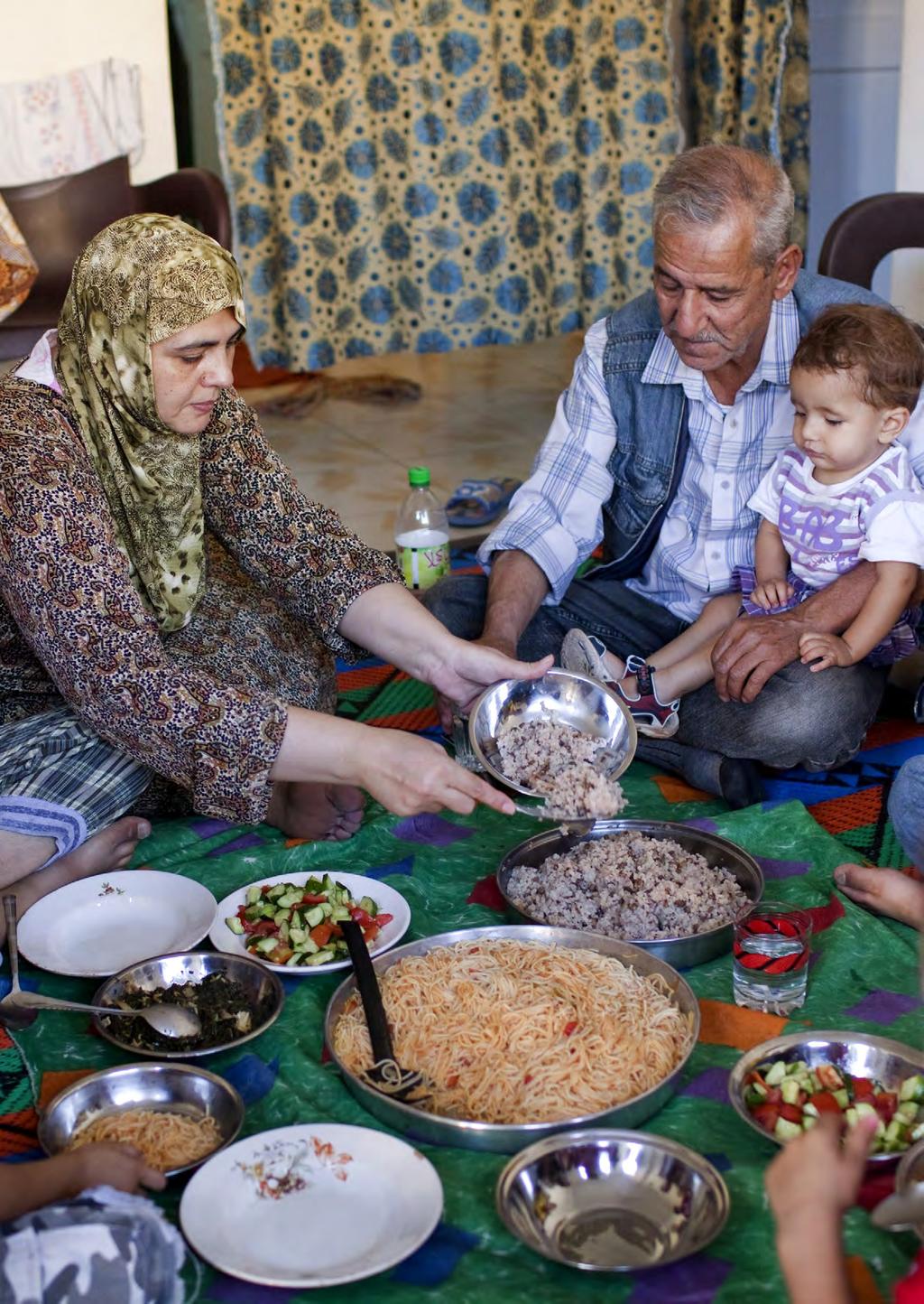 Fifty-year-ld Mazez serves dinner fr her family in their rented apartment in a neighbrhd in