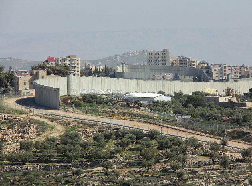 The West Bank is divided by the Israeli-built security barrier. The concrete barrier is replaced by a double metal fence in less populated areas, with a guardway in the middle.