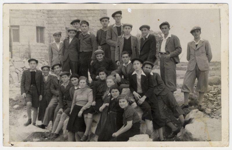 USHMM Photo Archives #67630 MAY 1939 BRITISH GOVERNMENT RESTRICTS IMMIGRATION INTO PALESTINE Recent Youth Aliyah immigrants to Palestine gather in front of the Horev boarding school.