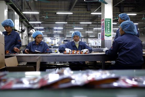 Bloomberg Workers package Nescafé at a Nestlé factory in Dongguan in southern China's Guangdong province.