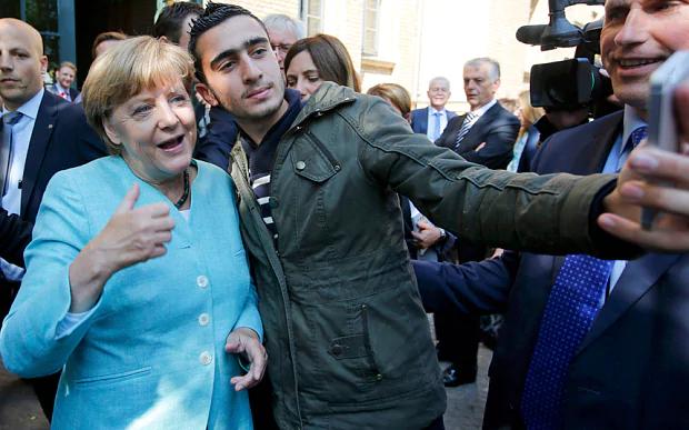 A refugee takes a selfie with German Chancellor Angela Merkel outside a refugee camp in Berlin Photo: REUTERS In Hungary, the top question on Google is "How should Christians respond to the migrant