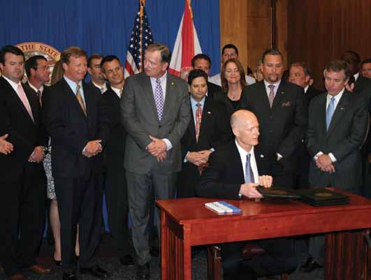 Governor Rick Scott is joined by representatives of Florida s business community including AIF s Brewster Bevis at the signing of HB 7087 a key economic development package designed to help various