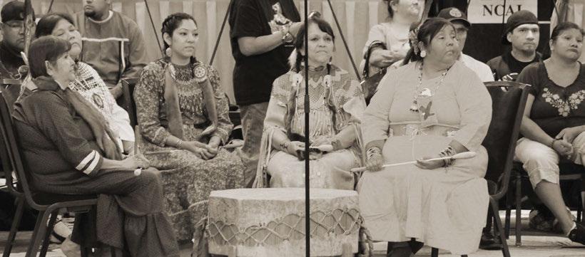 Above: Singers and drummers listen to remarks by Billy Mills at the Cultural Night hosted at Mid Year Conference.
