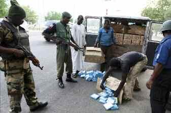 AP/PA Photo/Sunday Alamba Above: Soldiers stand guard at a road junction prior to President Goodluck