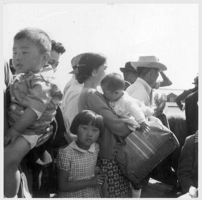 Turlock, Calif. Evacuees of Japanese ancestry waiting their turn for baggage inspection for contraband, upon arrival at this Assembly point.