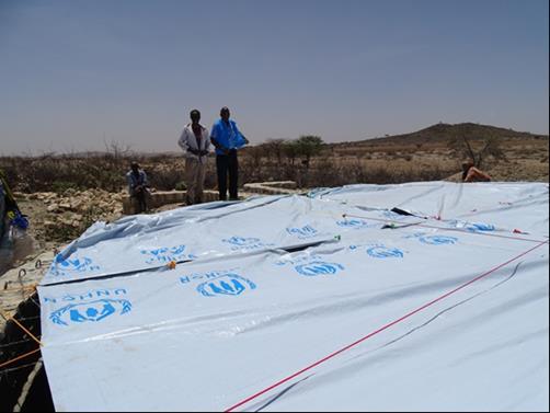 Andi - March 2016 UNHCR/F. Andi - March 2016 UNHCR staff and a little girl pose next to the covered Berkerd in The installation of the water tank in Dila. UNHCR/F. Andi - March 2016 the drought affected area in Goroyocawl village near Borama, Somaliland.