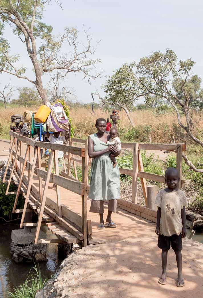 CHAPTER 2 UGANDA. SOUTH SUDANESE REFUGEES CROSS THE KAYA RIVER TO SAFETY USING A BRIDGE BUILT BY UNHCR.