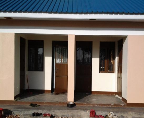 1. Newly constructed one-room teacher housing units 2. Pupils entering an EAC constructed classroom.