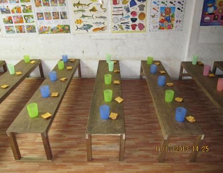 School tables of unpolished plywood that the students often get splinters from have been replaced with smooth surfaced