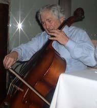 Wolfensohn playing the Kse diev, an ancient Cambodian string instrument Above: Mr.