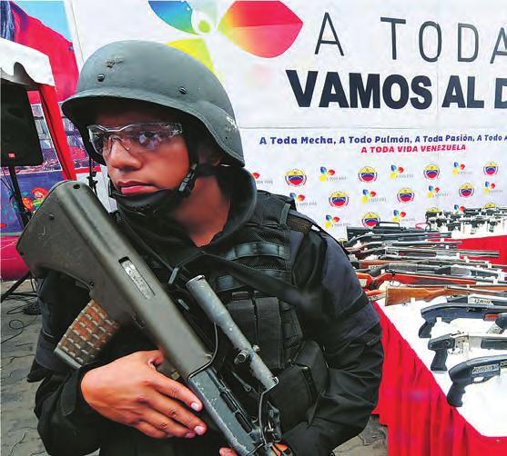 SUSTAINING SECURITY: COMMUNITY POLICING IN THE AMERICAS NANCY E. BRUNE Returned weapons and safer streets: A police officer in Caracas guards an event to eliminate seized weapons in June 2013.