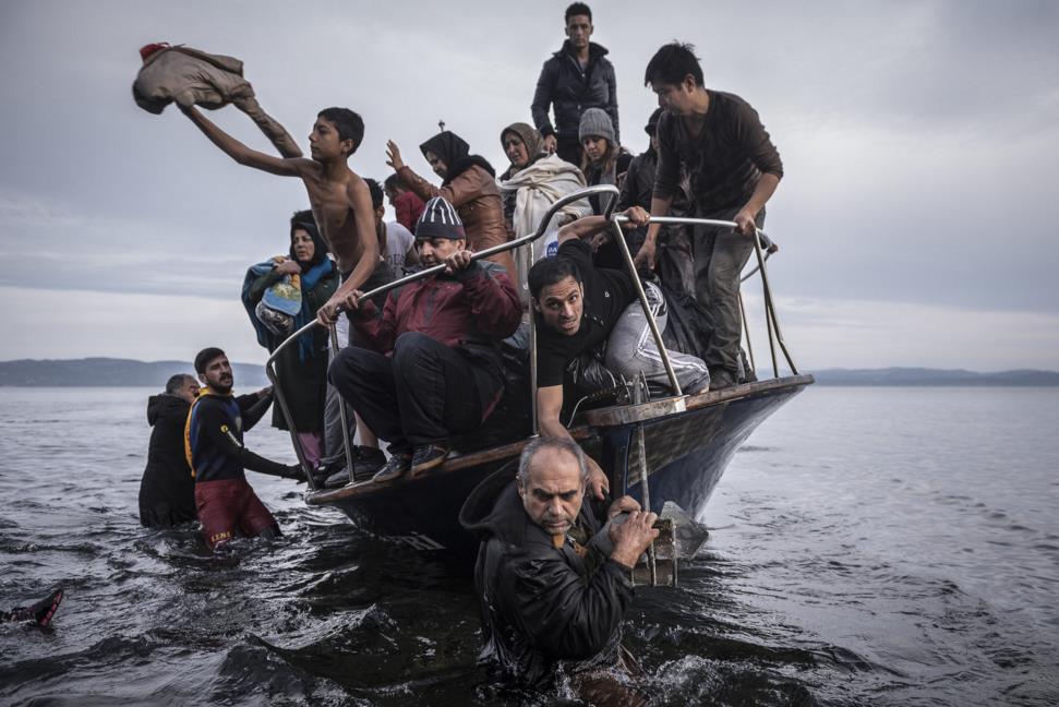 Nov. 16, 2015. Migrants arrive by a Turkish boat near the village of Skala, on the Greek island of Lesbos.