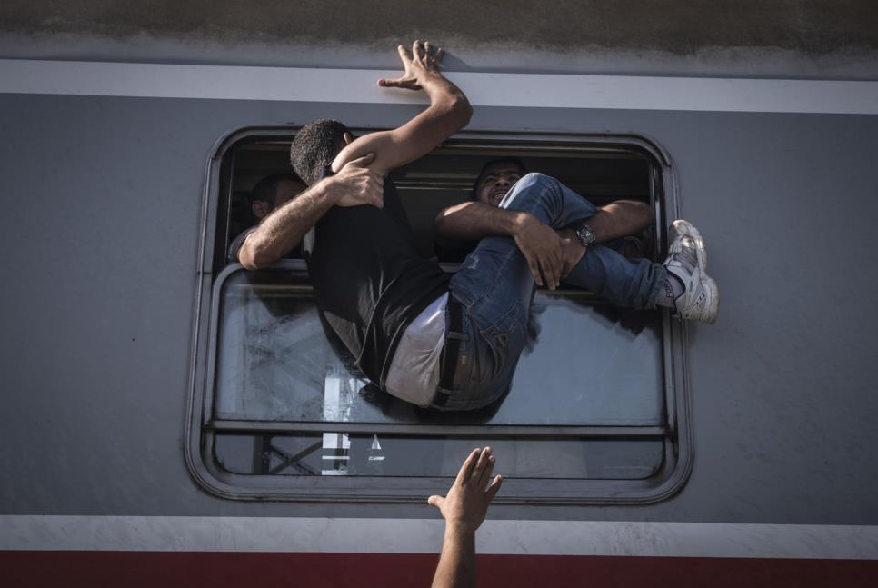 Sept. 18, 2015. Desperate refugees board the train toward Zagreb at Tovarnik station on the border with Serbia.