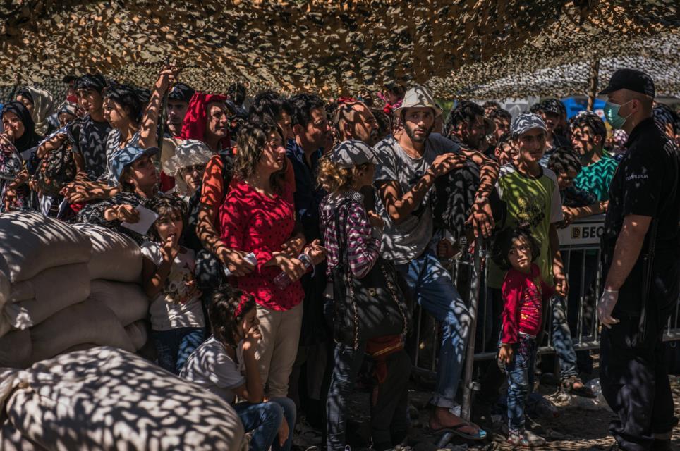 Aug. 27, 2015. Refugees wait in line for documents at a processing center in Presevo, Serbia.