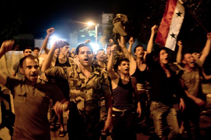 Assad regime soldiers celebrate Bashar Assad's presidential re-election in Damascus, Syria, Wednesday, 4 June 2014 [AP/Dusan Vranic] Abstract With interest in the Geneva conference s lacklustre