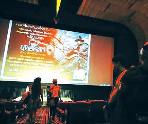 world Thai scholar faces royal insult charge over mediaeval king The Legend of King Naresuan is seen on a movie screen as people attend during a reconciliation event organized by the military in