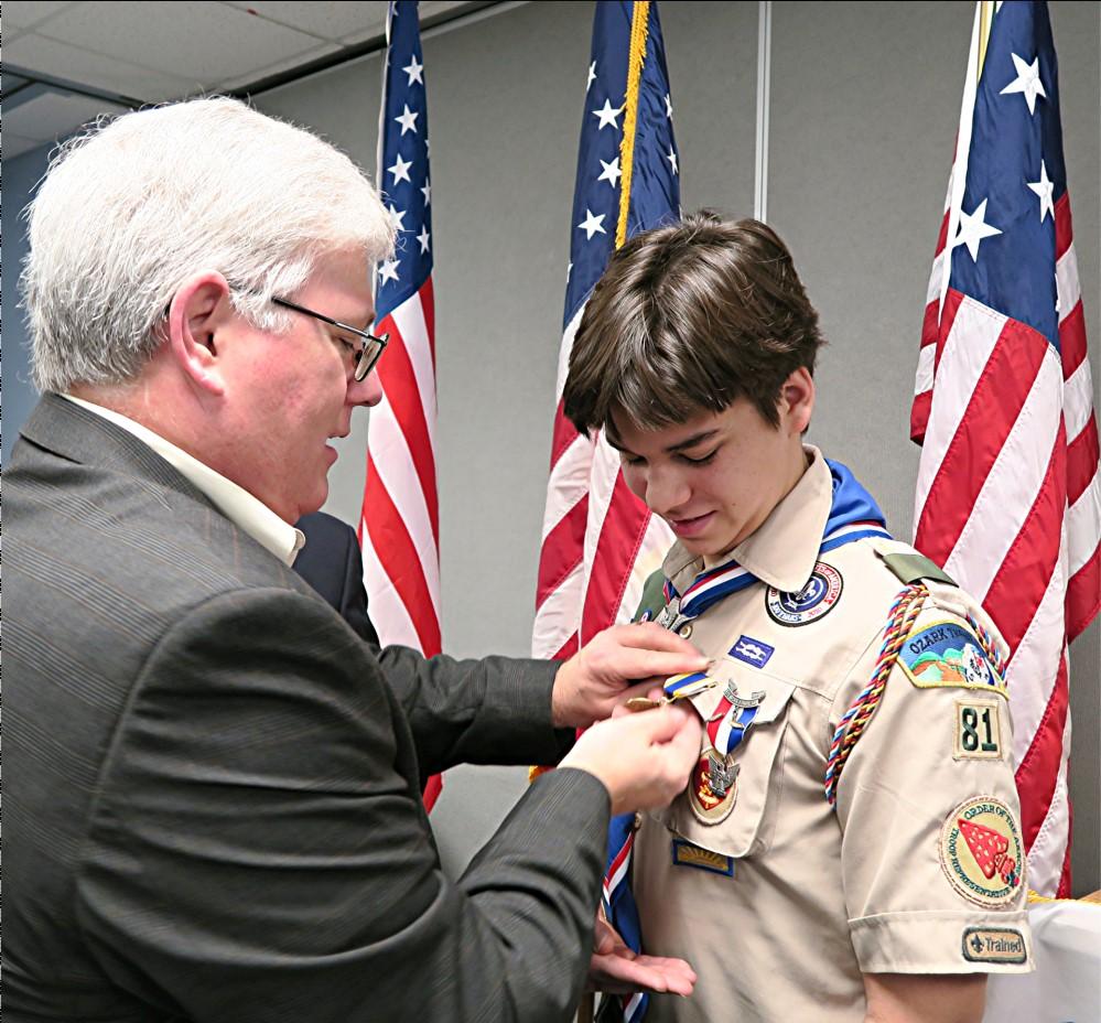 Howard Fisk (left), Compatriot Gary Bishop, Ozark Mountain Eagle Scout Chairman, presented Eagle Scout Marcus Peter Baur with a Missouri Society Certificate of