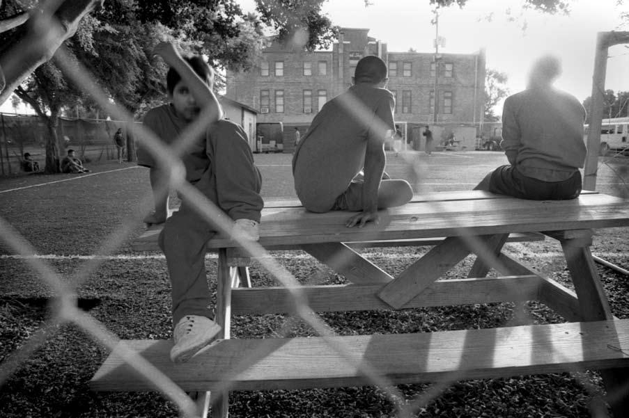 Unaccompanied boys in ORR detention wait for their turn to play ball. When ordered deported, these boys wait for prolonged periods as arrangements are made for their return to their country of origin.