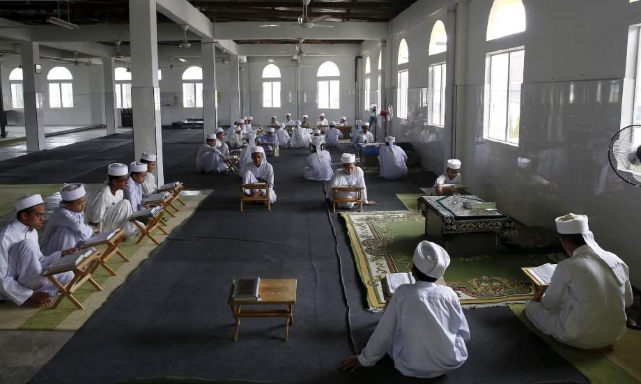 Students studying the Qur an at the Nurul Iman madrasah outside Malaysia s capital Kuala Lumpur, September 11, 2015.