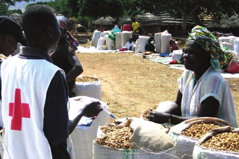ICRC IN UGANDA fact sheet 2009 A Red Cross volunteer inspects seeds during a seed fair at Agoro market, Kitgum district in March.
