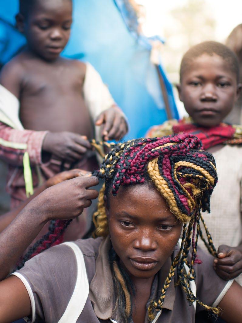 Chapter 4 Democratic Republic of the Congo. Mbuyu, a 25-year-old IDP in the Democratic Republic of the Congo, has her hair braided by her little sisters.