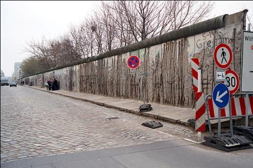 TO stop people from fleeing to the west, a wall is built between East and West Berlin.