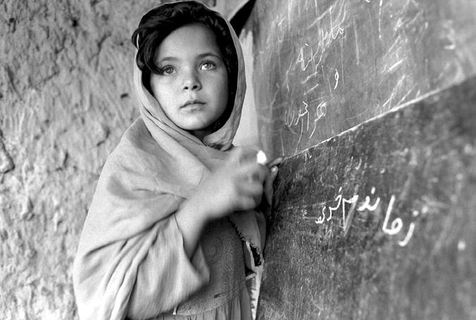28 The United States in Afghanistan UN Photo. Roger Lemoyne. A girl studies in a community-based school in Nangarhar province.