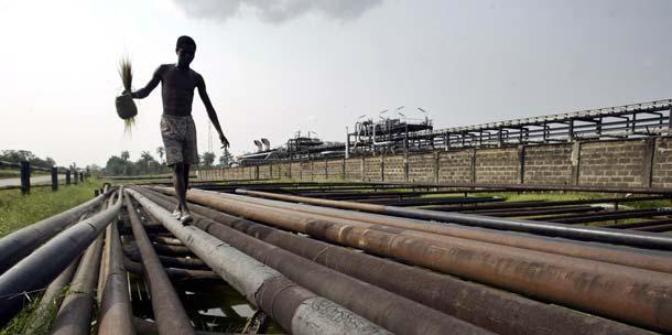 Back to this item SOURCE: AP/George Osodi An unidentified youth walks on an oil pipeline in Idu Ogba, Nigeria. The United States imported 4 million barrels of oil a day or 1.